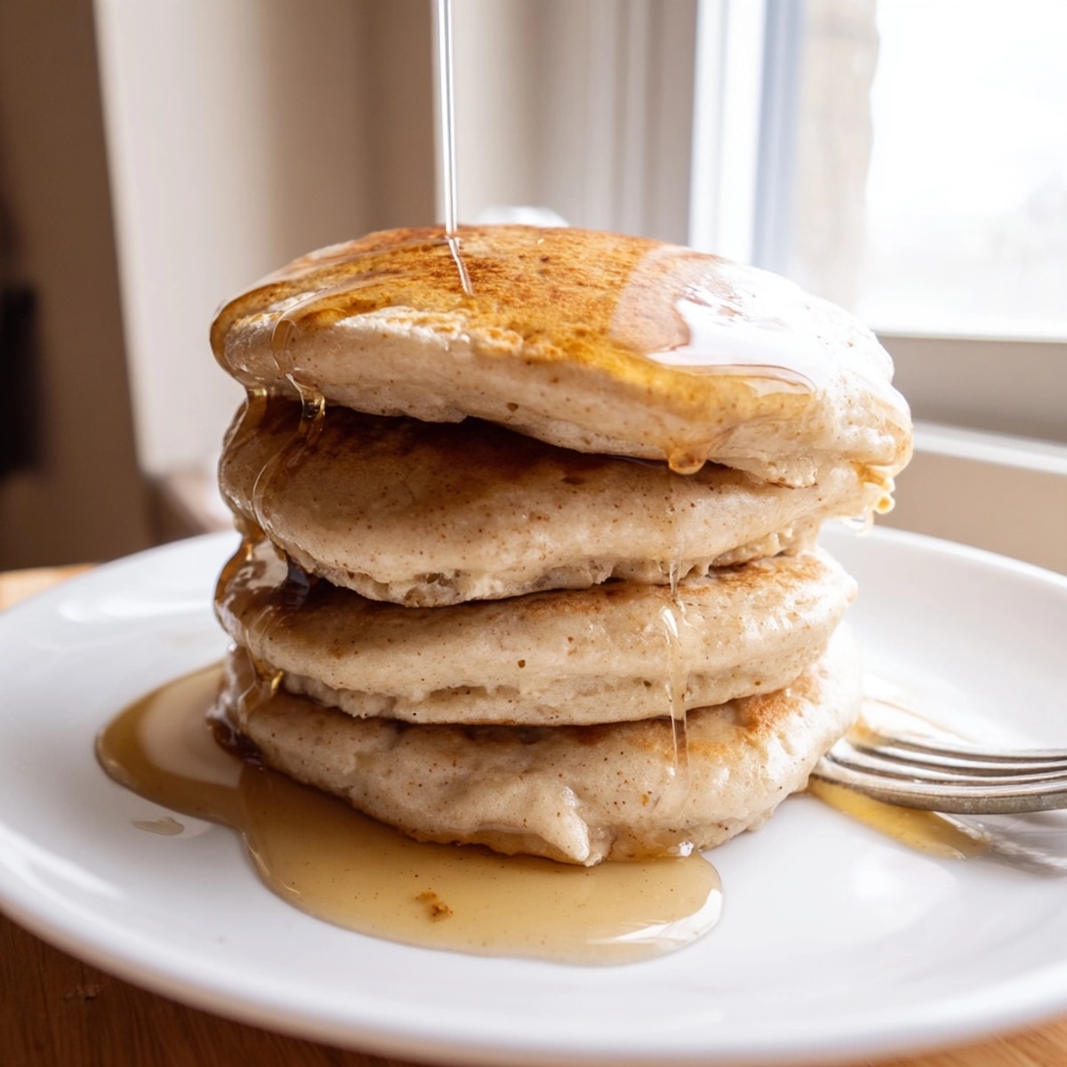 Fluffy Maple Protein Pancakes with berries and nuts, a protein-packed breakfast delight.