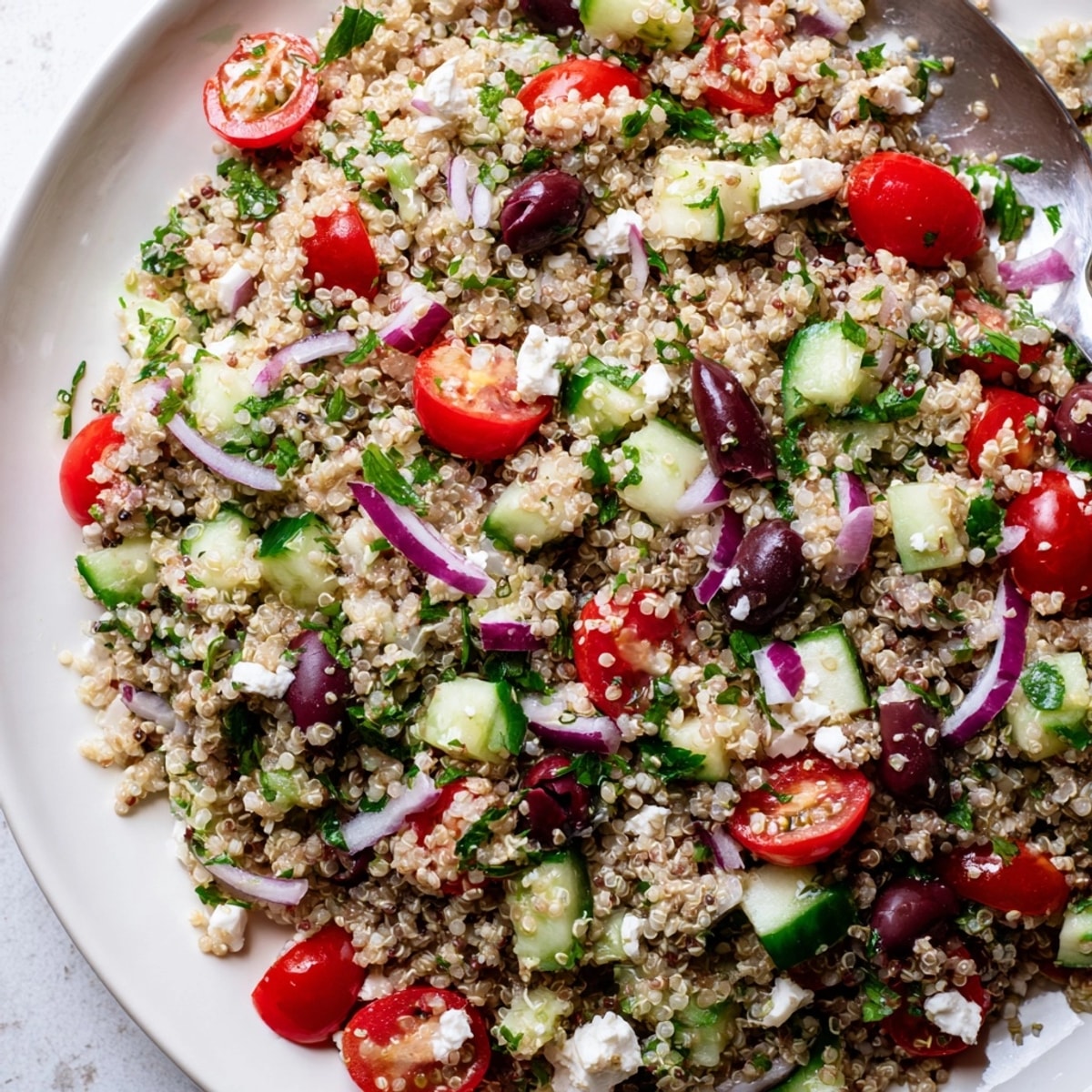 A vibrant bowl of Mediterranean Quinoa Salad – ready to be served al fresco.