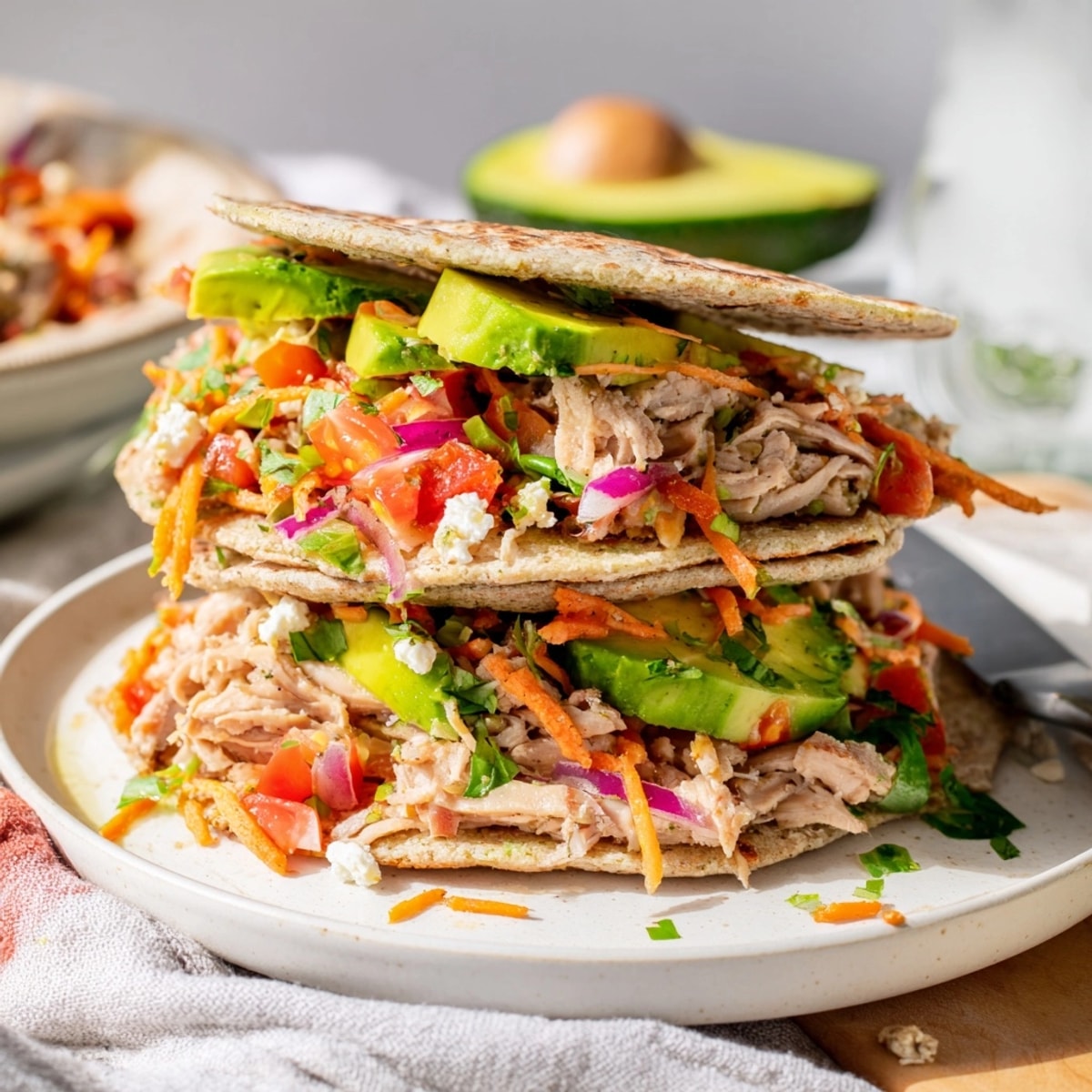 Healthy Chicken Avocado Wrap sliced in half, vibrant with colors, ready to eat.