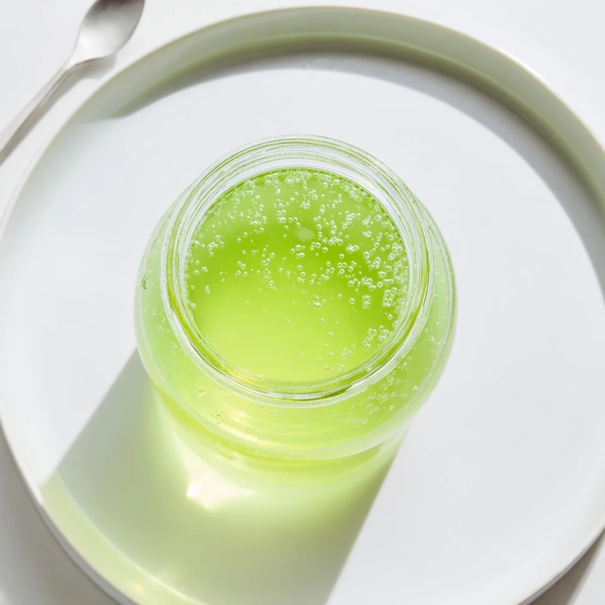 Vibrant peppermint flavor syrup swirling beautifully, perfect for adding refreshing taste to any treat.