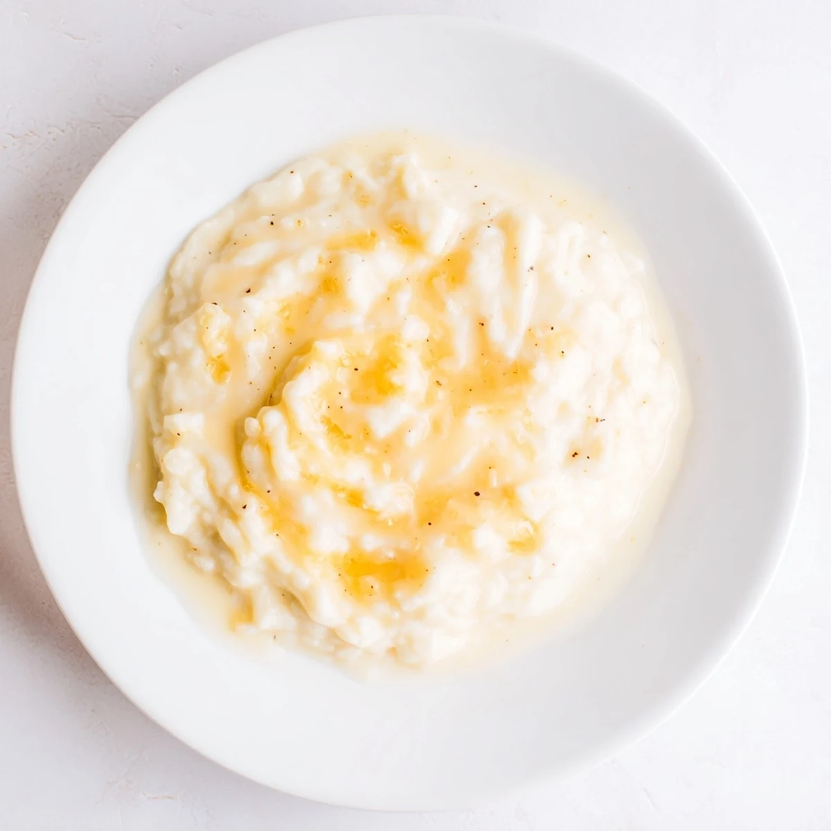 Thick and cheesy creamy cheese sauce, ready to pour over broccoli with a subtle nutmeg aroma.