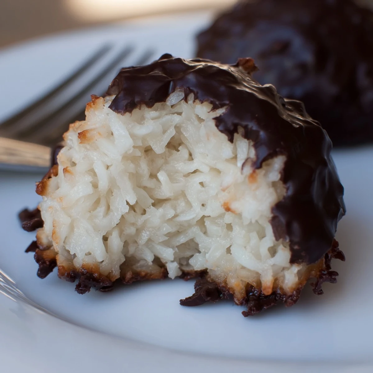 A plate of fresh Chocolate Dipped Coconut Macaroons, featuring a sweet, coconutty delight.