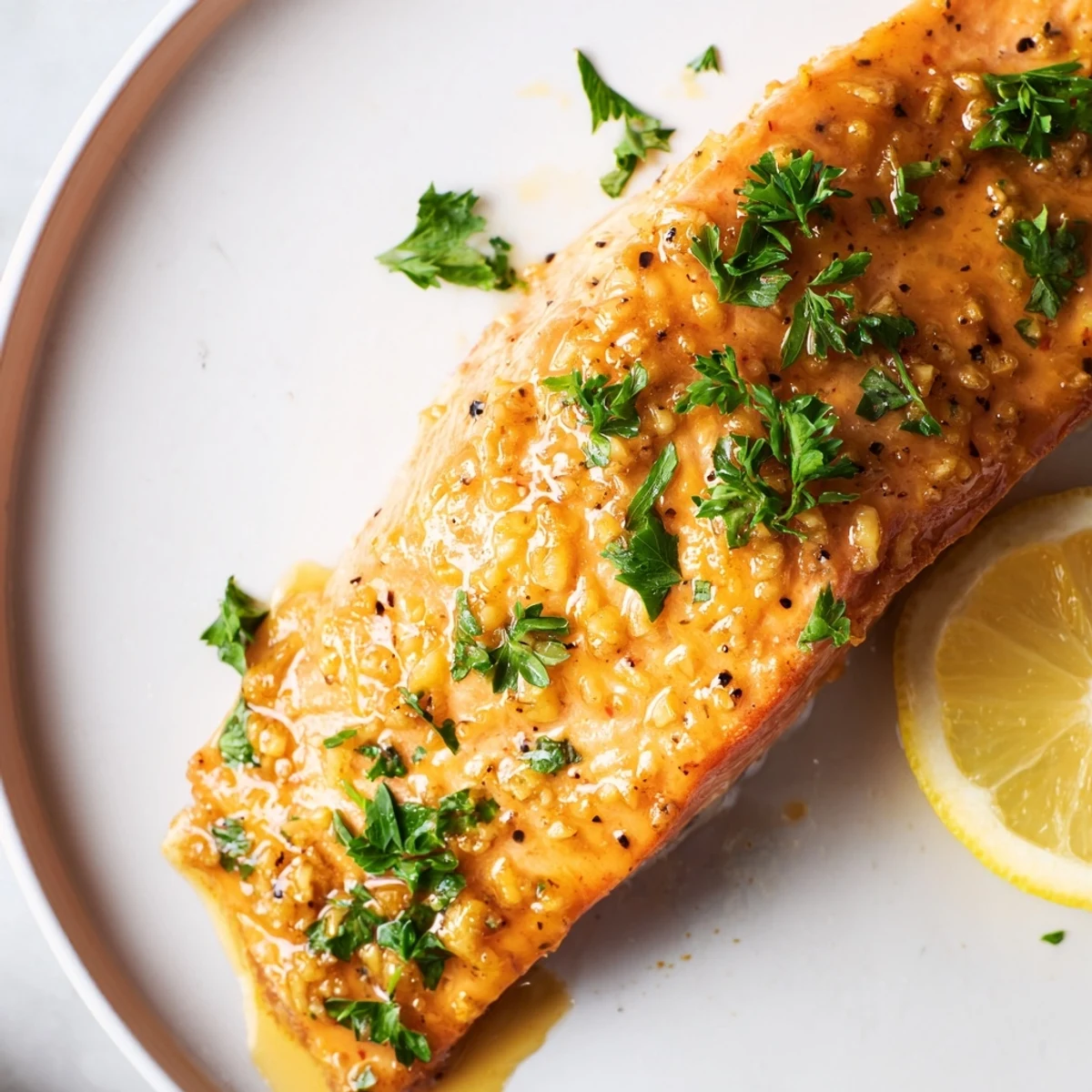 Tender Honey Garlic Glazed Salmon, cooked to perfection, showcasing the beautiful glazed finish with fresh parsley.