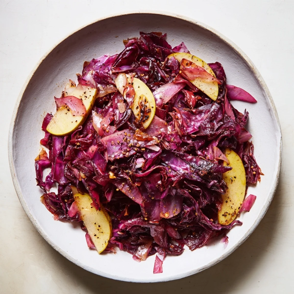 Savory Braised Red Cabbage with Apple: see juicy reddish cabbage and cooked apples, ready to serve warm.