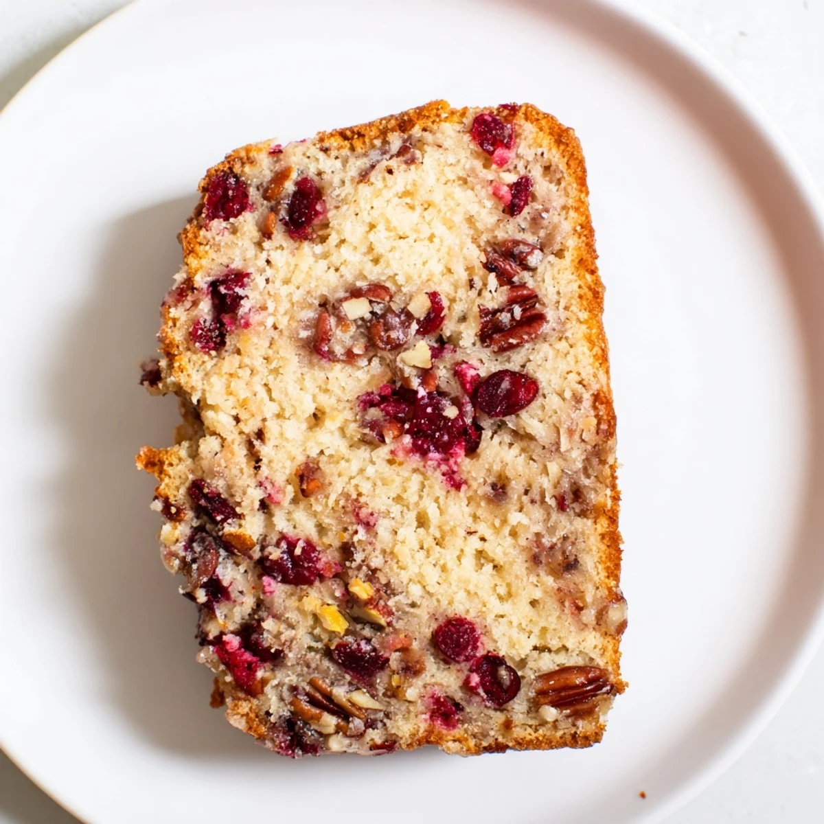Freshly baked cranberry pecan bread, studded with tart cranberries, ready to serve with coffee.