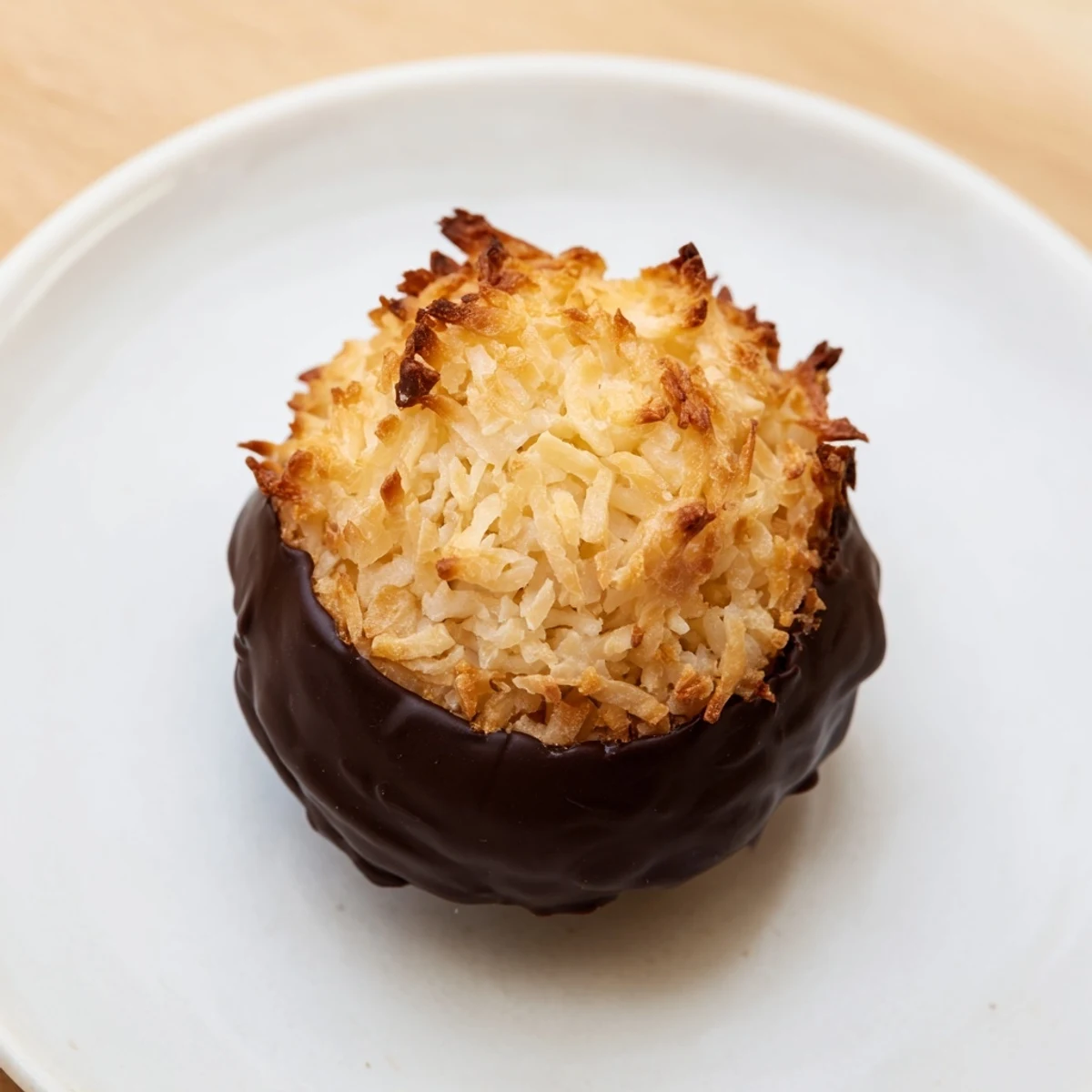 Golden-brown coconut macaroons, crisp outside and chewy within, ready for a sweet bite.
