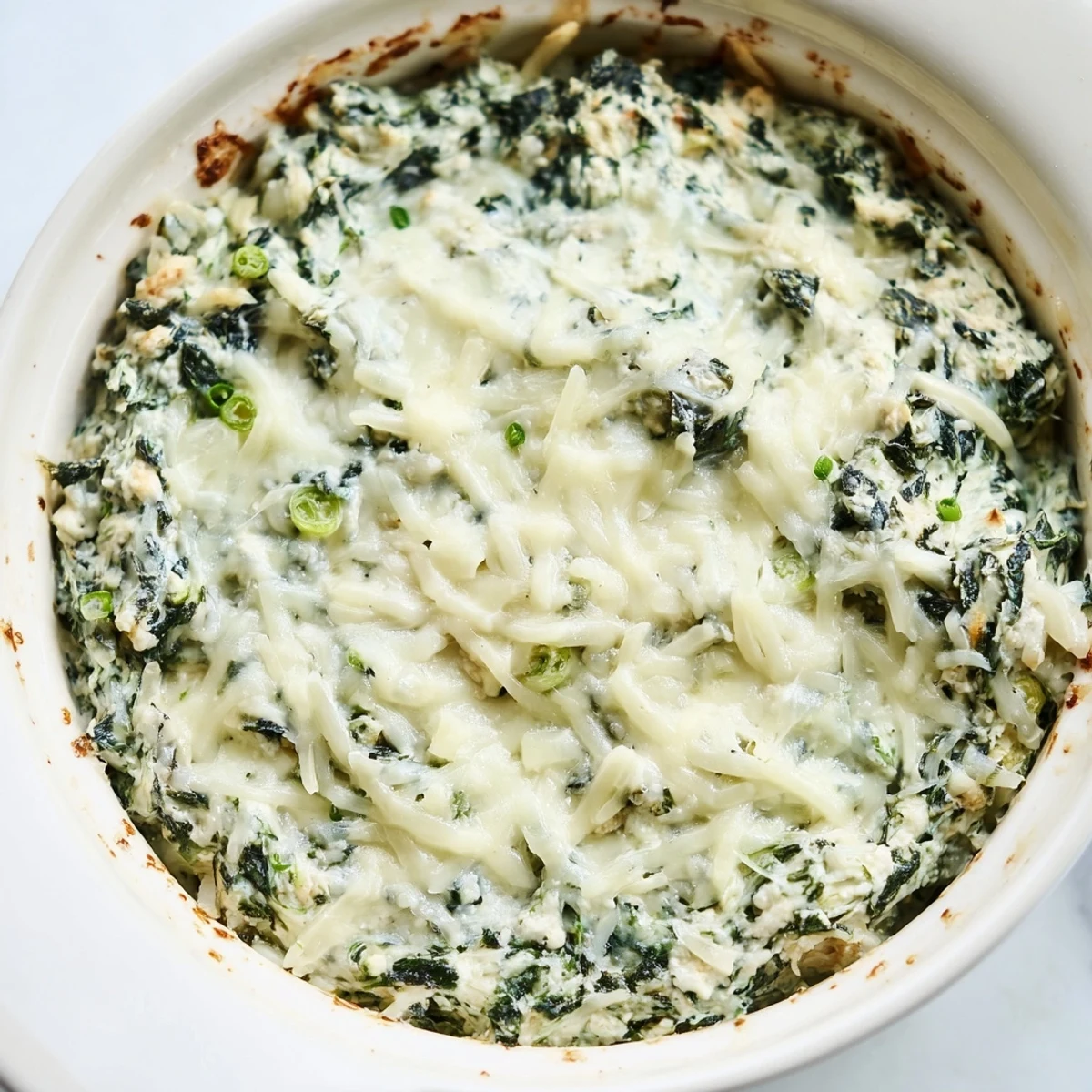 Golden-topped Spinach Dip, perfectly baked and served with crisp vegetable crudités.