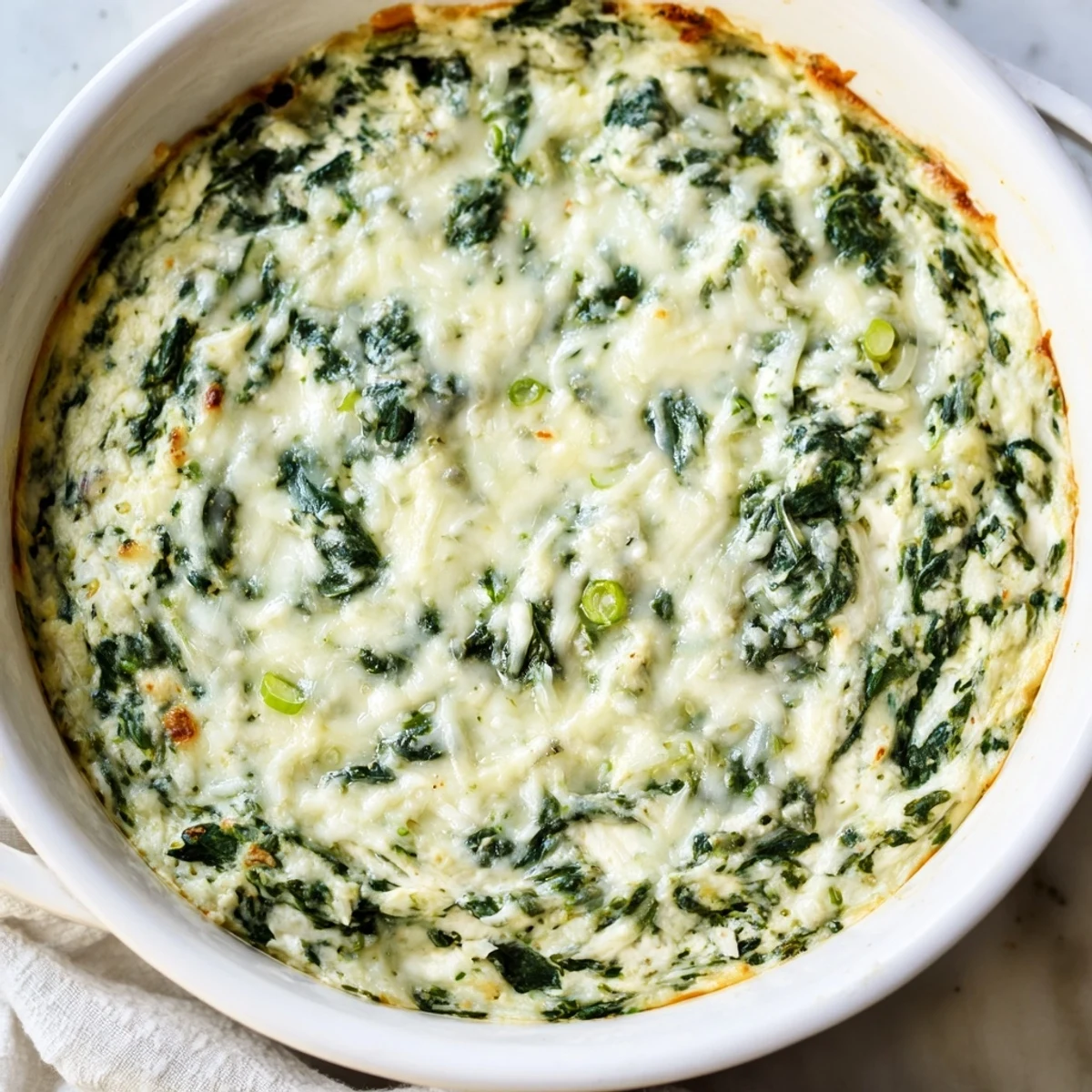 A bowl of creamy, hot Spinach Dip, a vegetarian favorite dip for any party spread.