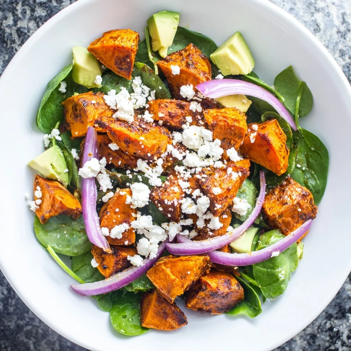 Vibrant overhead shot of a roasted sweet potato and feta salad ready to be enjoyed.