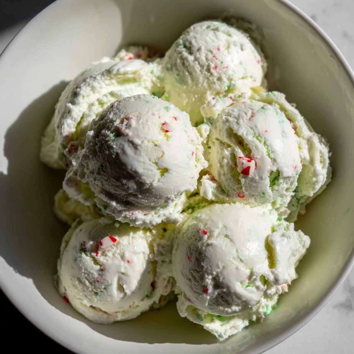 A quart of refreshing, white Peppermint Ice Cream swirled with peppermint pieces; a holiday favorite.