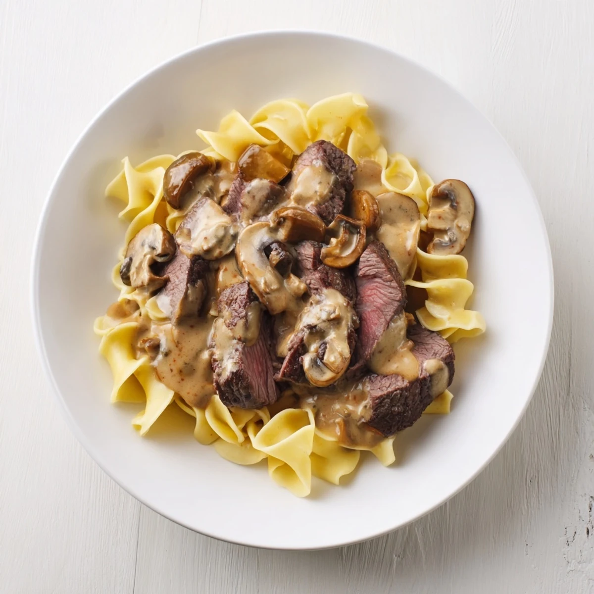 A steaming bowl of comforting beef stroganoff, a classic family meal ready to enjoy!