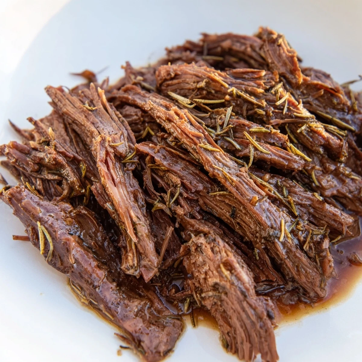 Slow Cooker Roast Beef simmering in a deep ceramic slow cooker pot, accompanied by tender carrots, potatoes, and onions in savory juices.