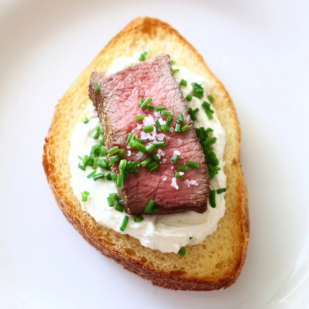Golden, crispy beef toast points topped with tender seared beef slices and creamy horseradish sauce.