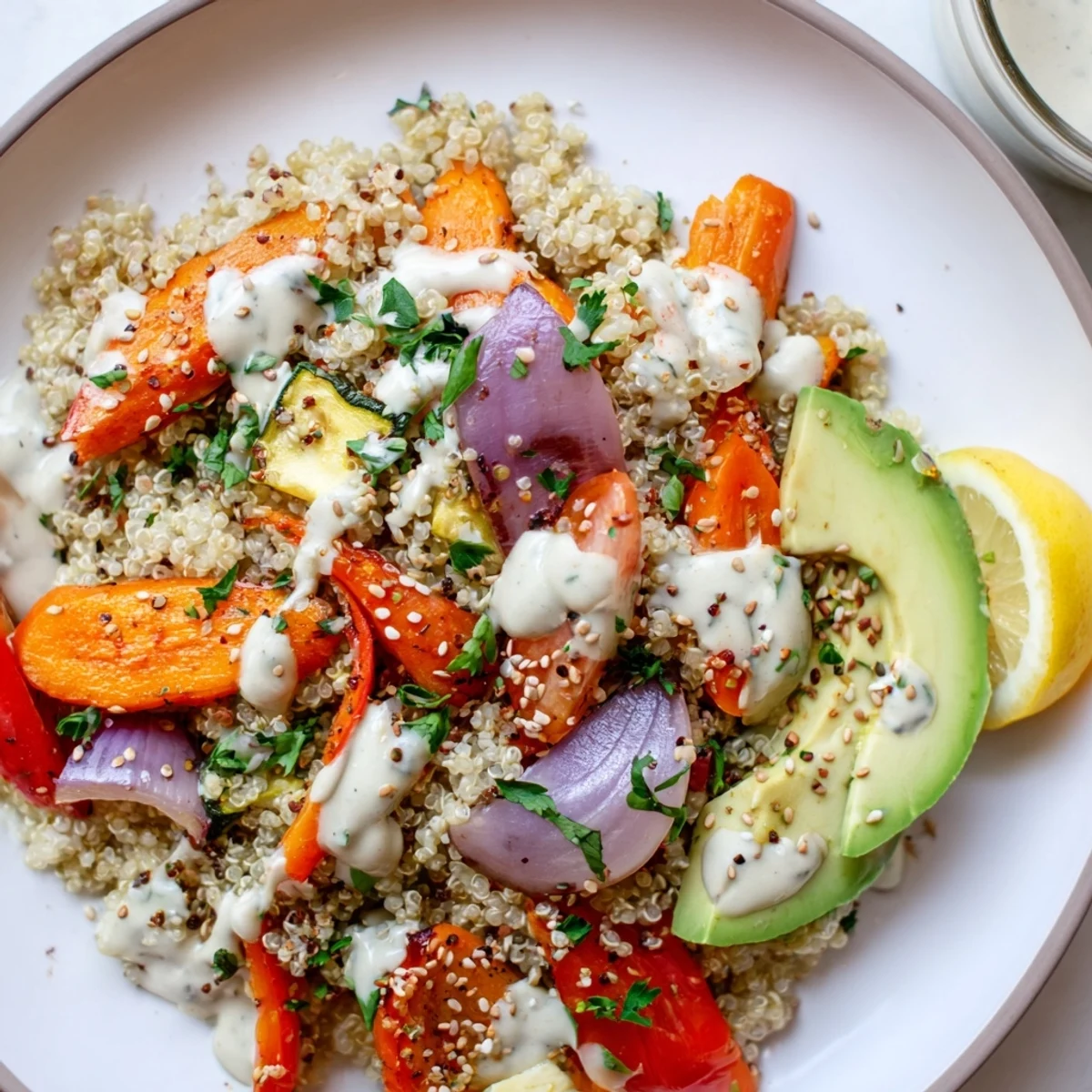 Colorful, oven-roasted vegetables and golden quinoa meet creamy lemon-tahini drizzle in this wholesome Roasted Vegetable Quinoa Bowl with Tahini Dressing, perfect for a quick dinner.