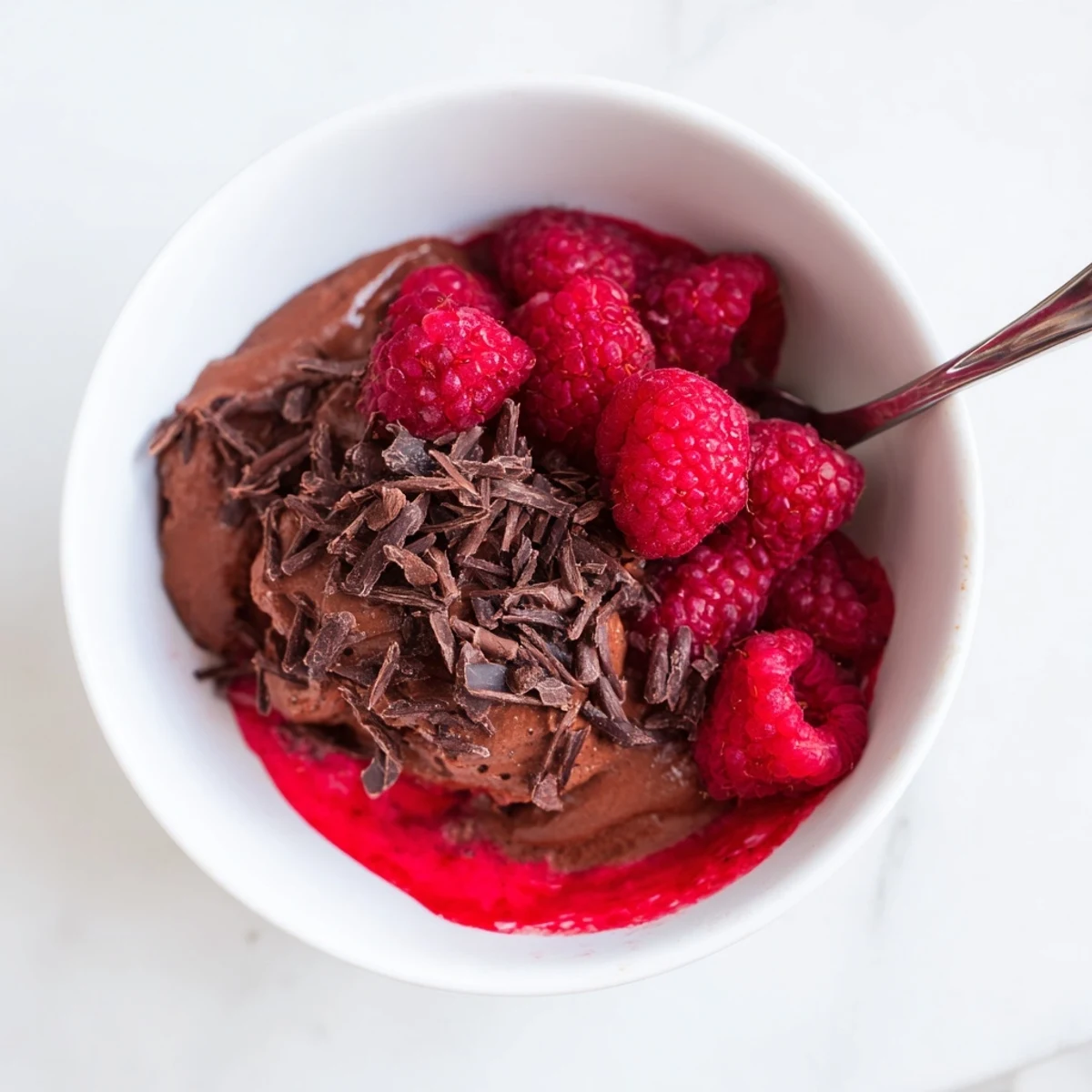 Airy chocolate mousse layered with bright raspberry coulis, perfect for an elegant dessert.