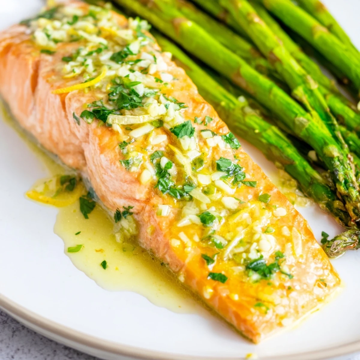Lemon Garlic Butter Salmon with Roasted Asparagus served on a rustic wooden board, garnished with fresh parsley.