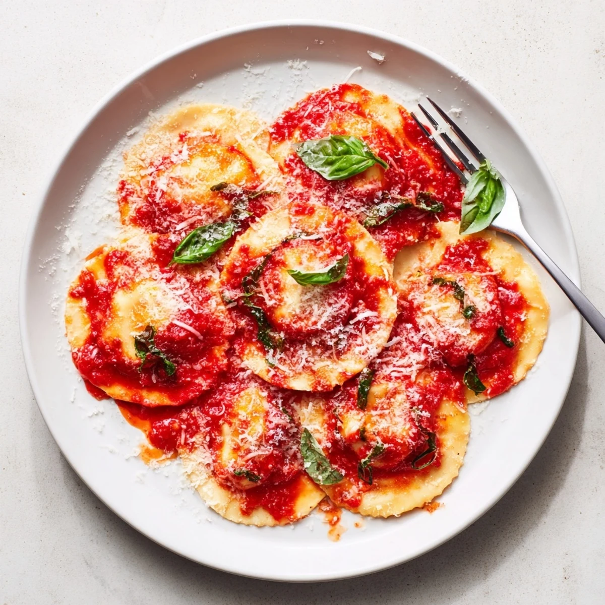 Freshly cooked ravioli with simple sauce, steaming and ready to serve on a cozy Italian dinner plate.