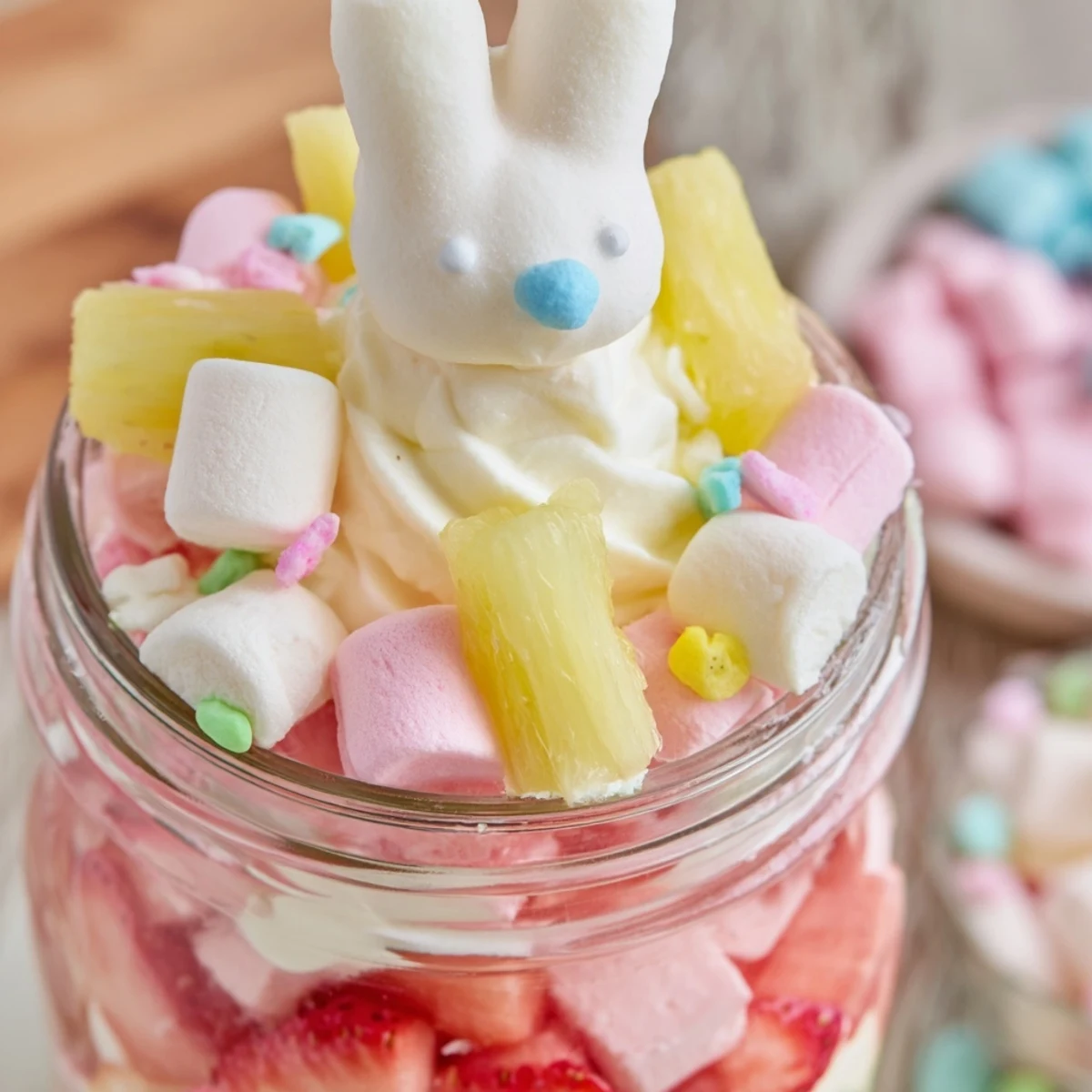 Festive spring dessert featuring colorful Jello Pie layers, mini marshmallows, and pastel sprinkles in a glass jar for Easter.