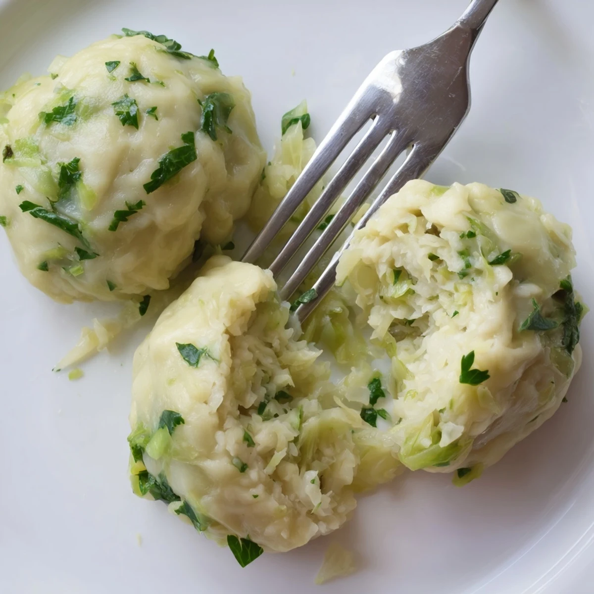 Tender German Cabbage Dumplings served hot with melted butter and a rustic bread backdrop.