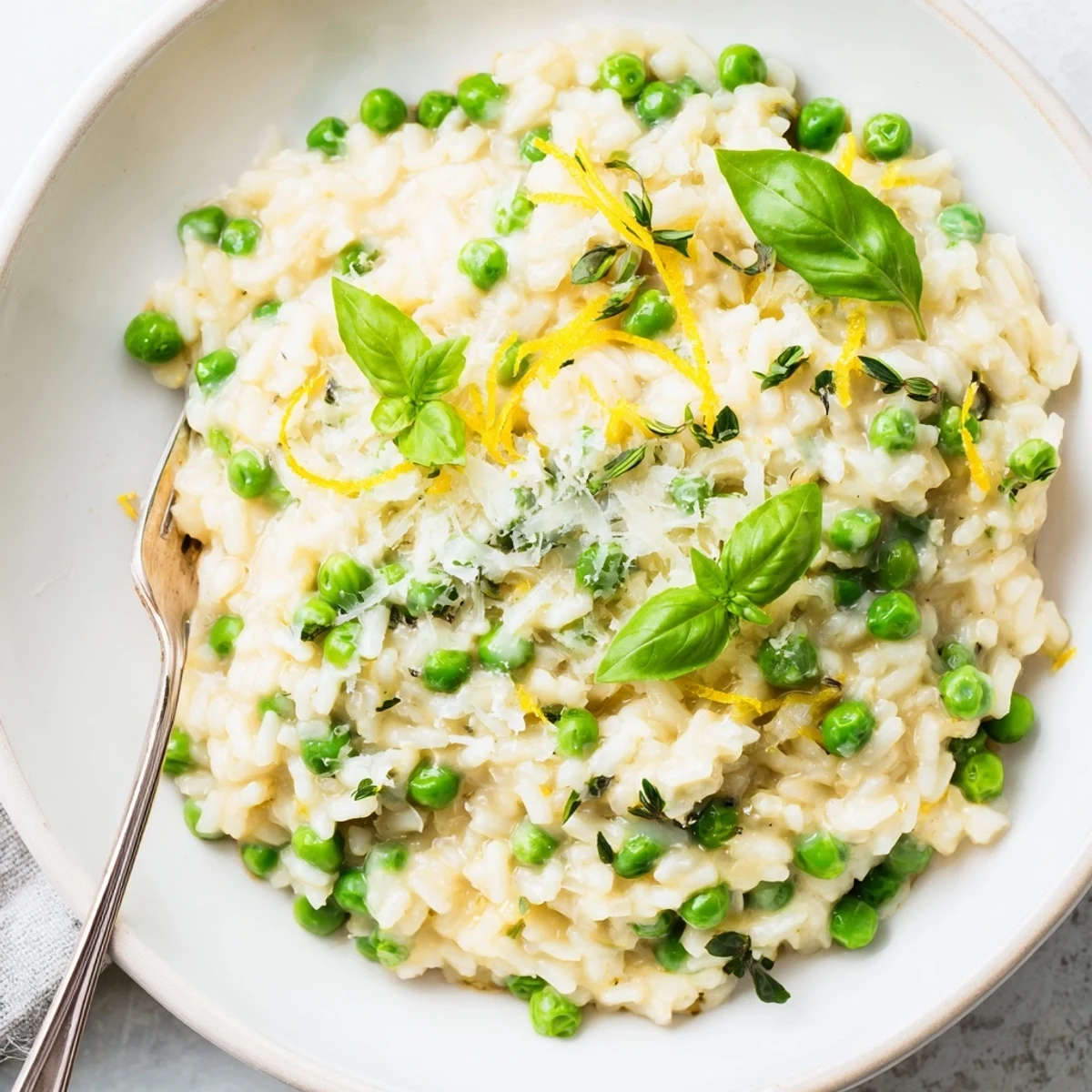 Vibrant green peas folded through al dente Arborio rice with melted Parmesan and herb garnish