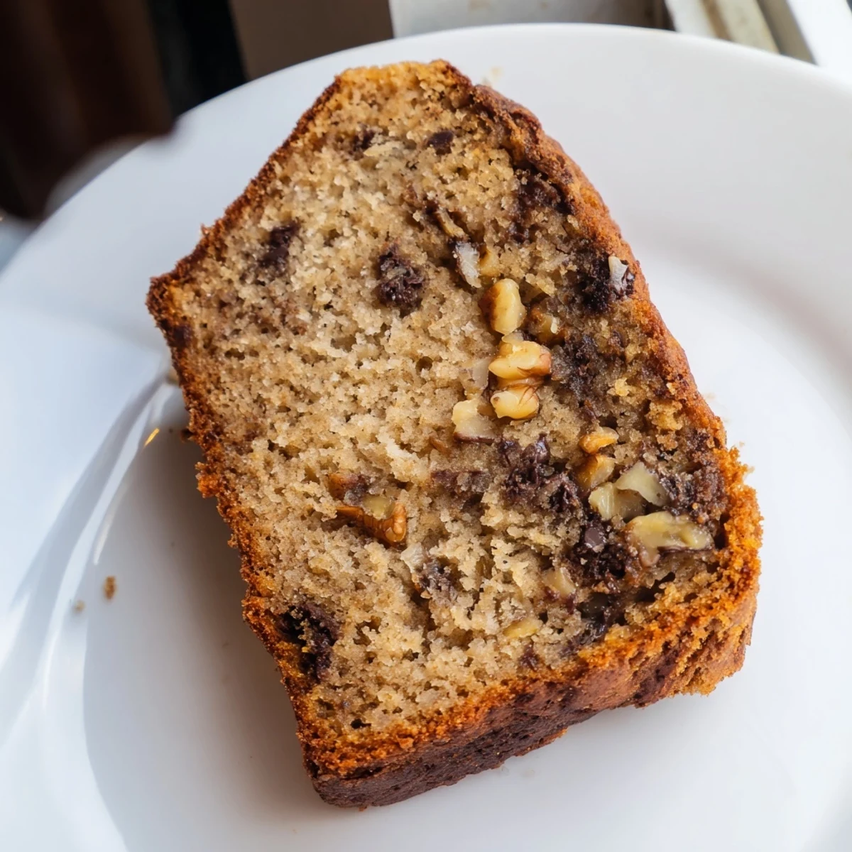 Freshly baked moist banana bread with mashed ripe bananas, cooling on a wire rack with steam rising