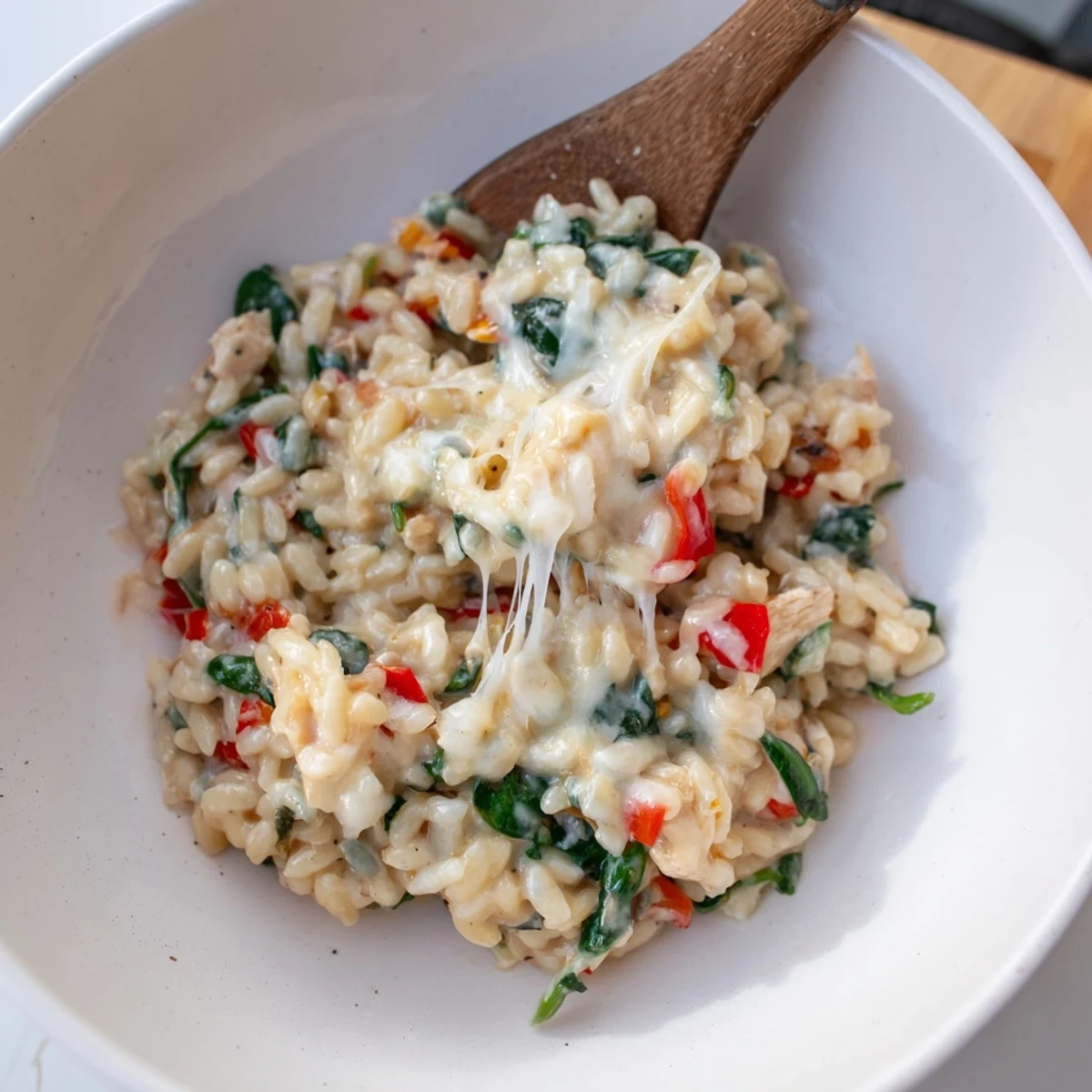 Golden chicken and tender orzo pasta in a rich cheese sauce with spinach and bell peppers