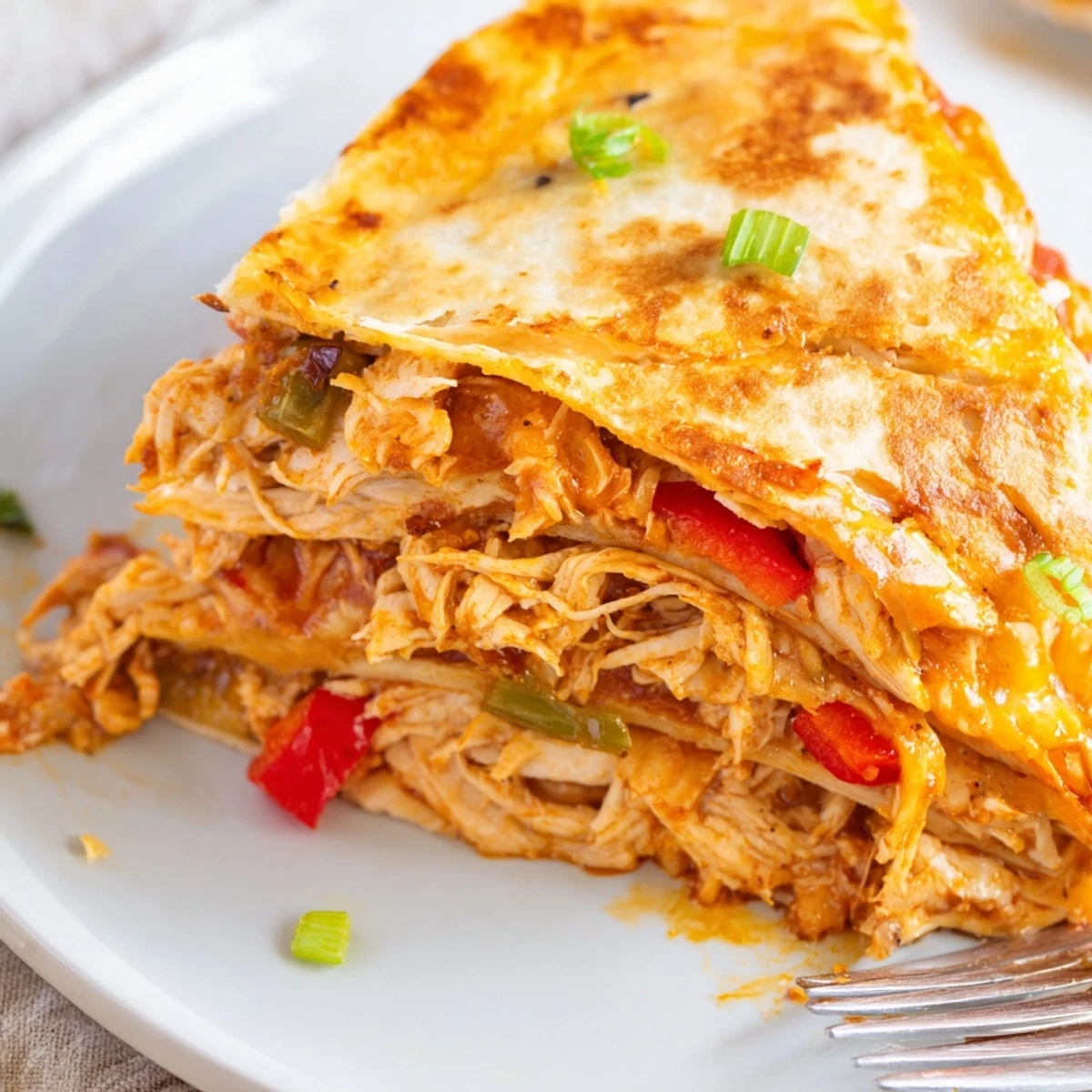 Golden brown easy baked chicken and cheese quesadillas with melted cheese and red bell peppers