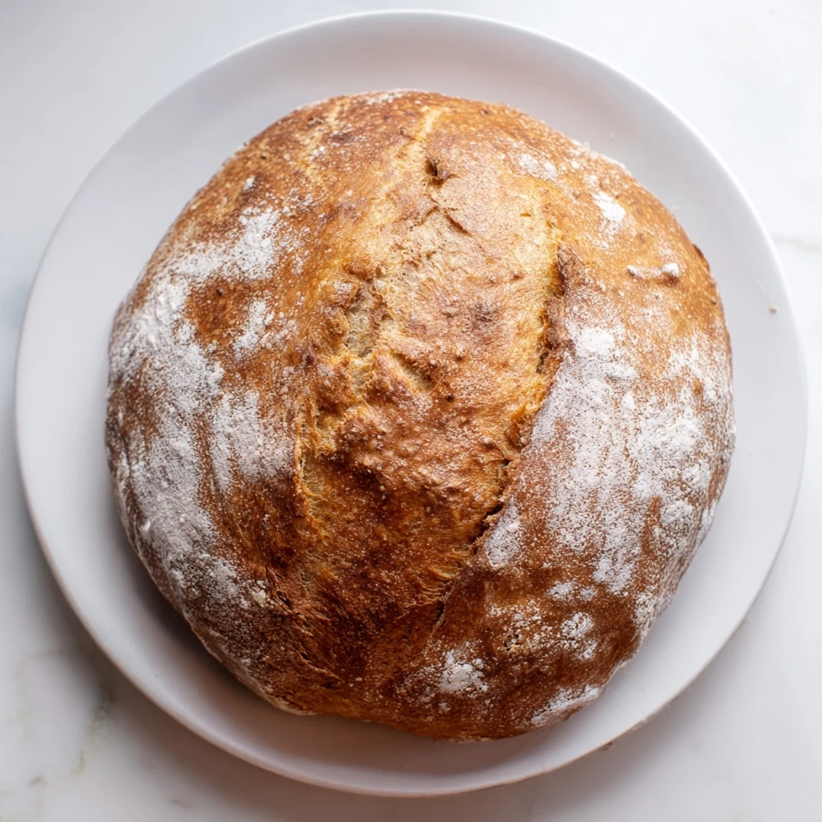 Golden crusty artisan no knead bread loaf with crackled surface and chewy interior