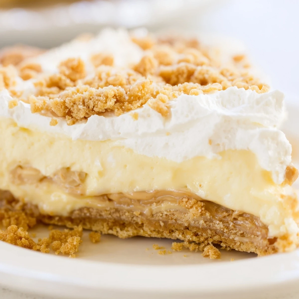 Old fashioned Amish peanut butter dream pie sliced revealing rich custard filling beneath billowy whipped cream