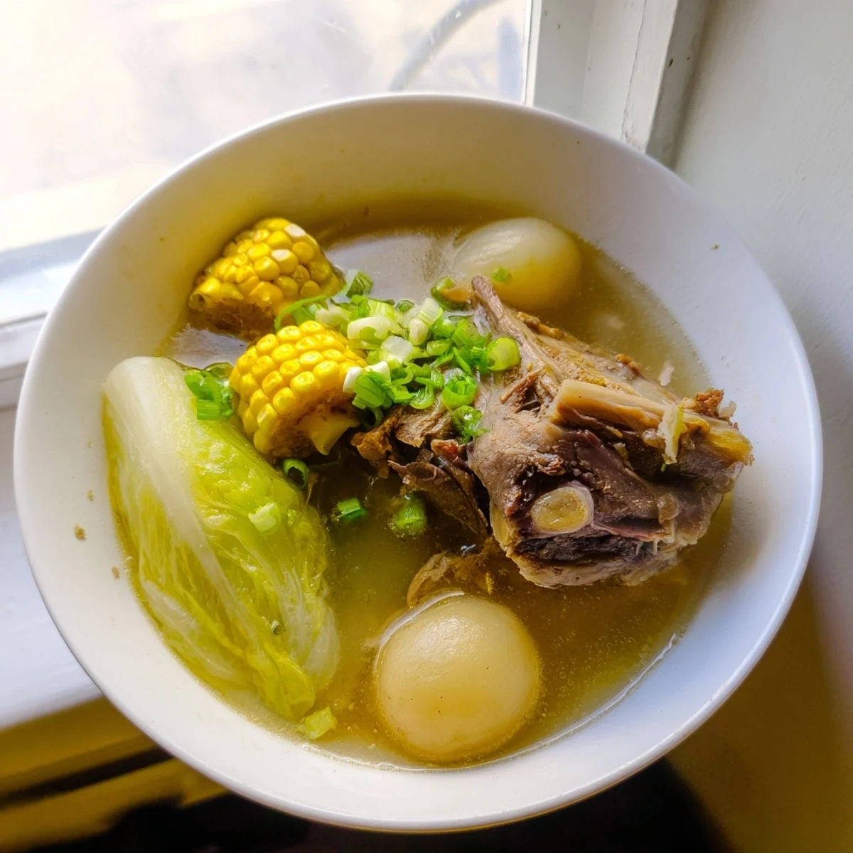 Filipino Bulalo Beef Shank Soup steaming in a bowl with tender meat and vegetables