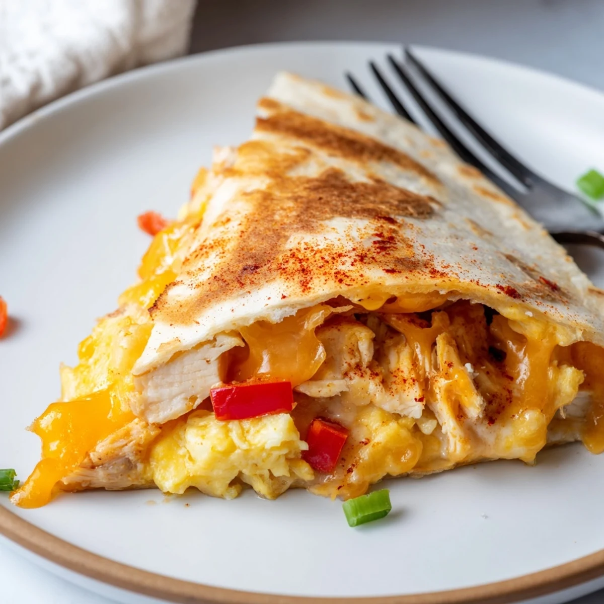 Golden, crispy Chicken Breakfast Quesadilla filled with melty cheese and scrambled eggs.