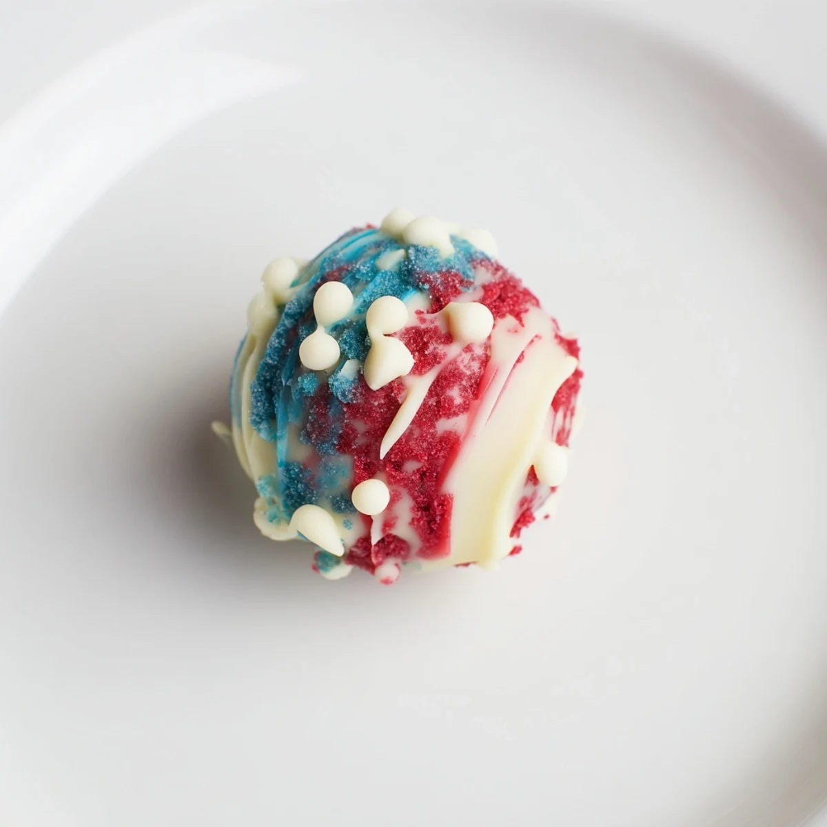 Hands rolling Of July Truffles Creamy And Patriotic, dusted in white sprinkles