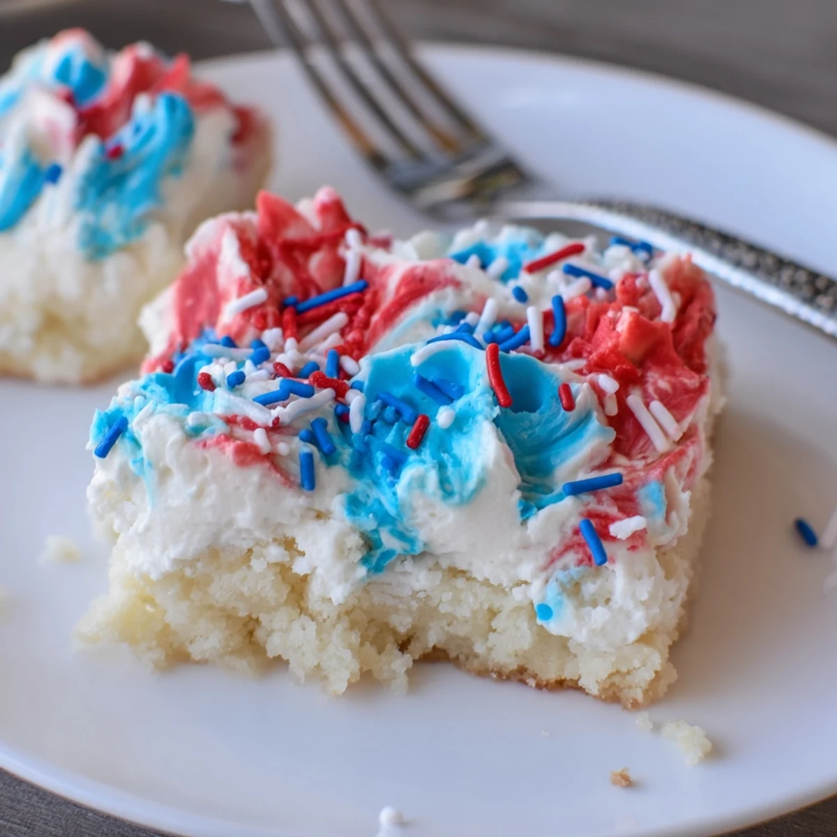 Soft Patriotic Sugar Cookie Bars topped with crunchy red, white, blue sprinkles