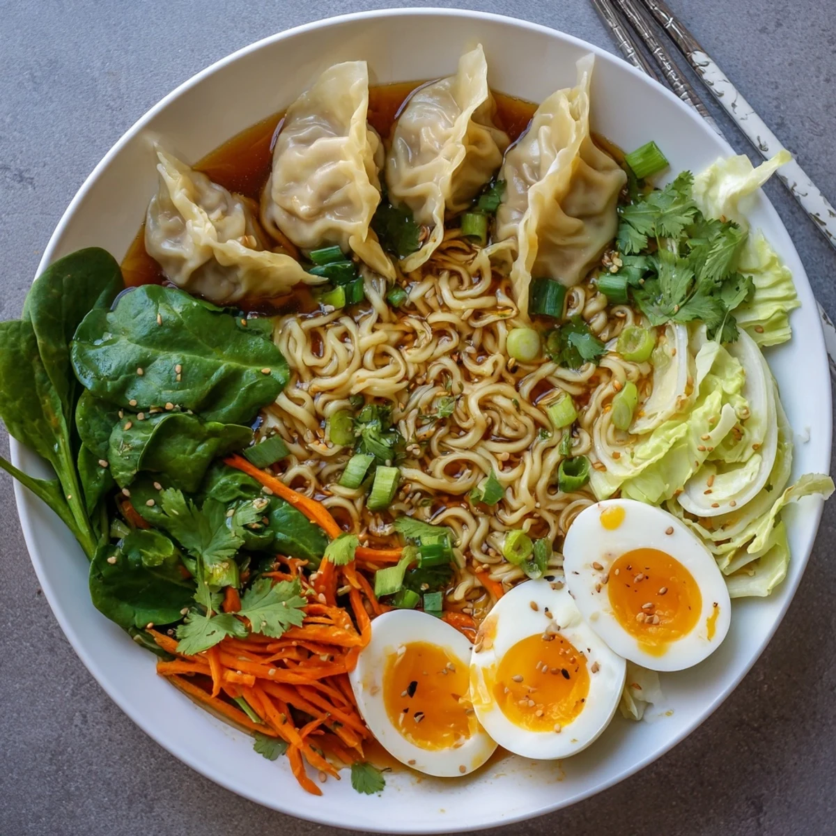 Steaming bowl of dumpling ramen featuring soft-boiled eggs, fresh spinach, and bok choy in savory broth