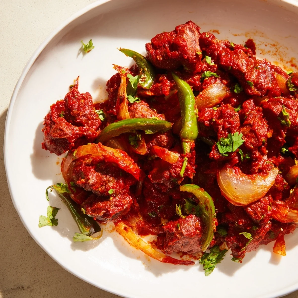 Traditional Kenyan goat wet fry showcasing succulent pieces in thick spiced gravy