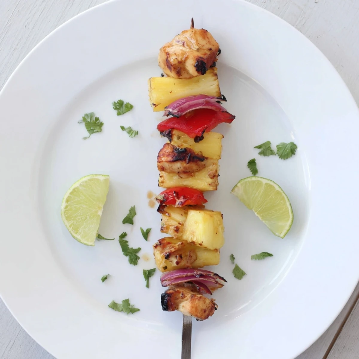 Savory Grilled Pineapple Chicken Kabobs marinated in honey-lime, resting on coconut rice.