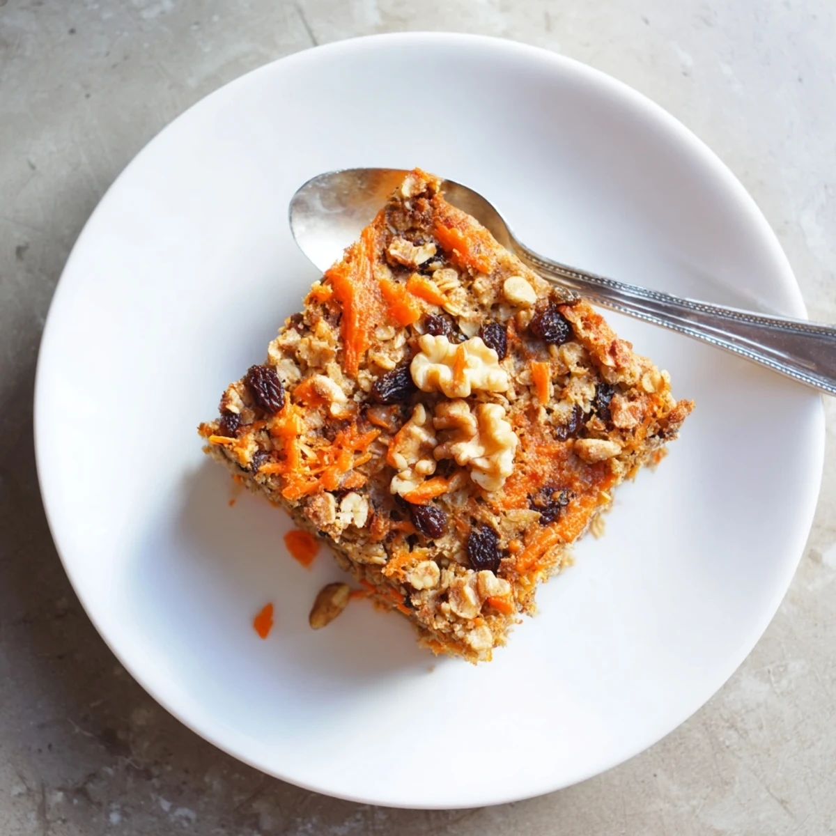 Golden baked carrot cake oatmeal with grated carrots, walnuts, and warm cinnamon spices