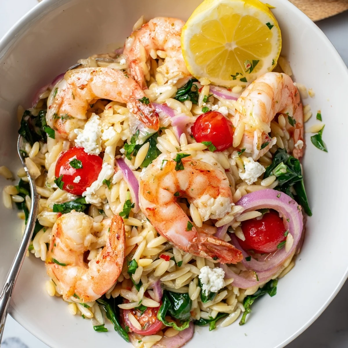Sizzling Lemon Feta Orzo Shrimp Recipe tossed with wilted spinach and juicy tomatoes