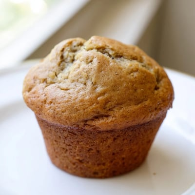 Soft banana muffins wrapped in paper liners dusted with cinnamon sugar