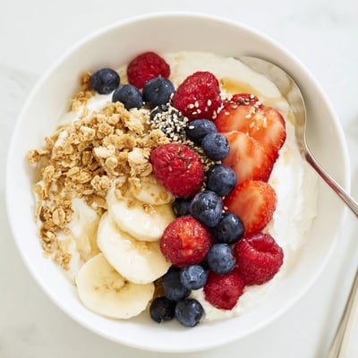Cottage Cheese Breakfast Bowl served in a rustic bowl, spoon ready, colorful fruit  